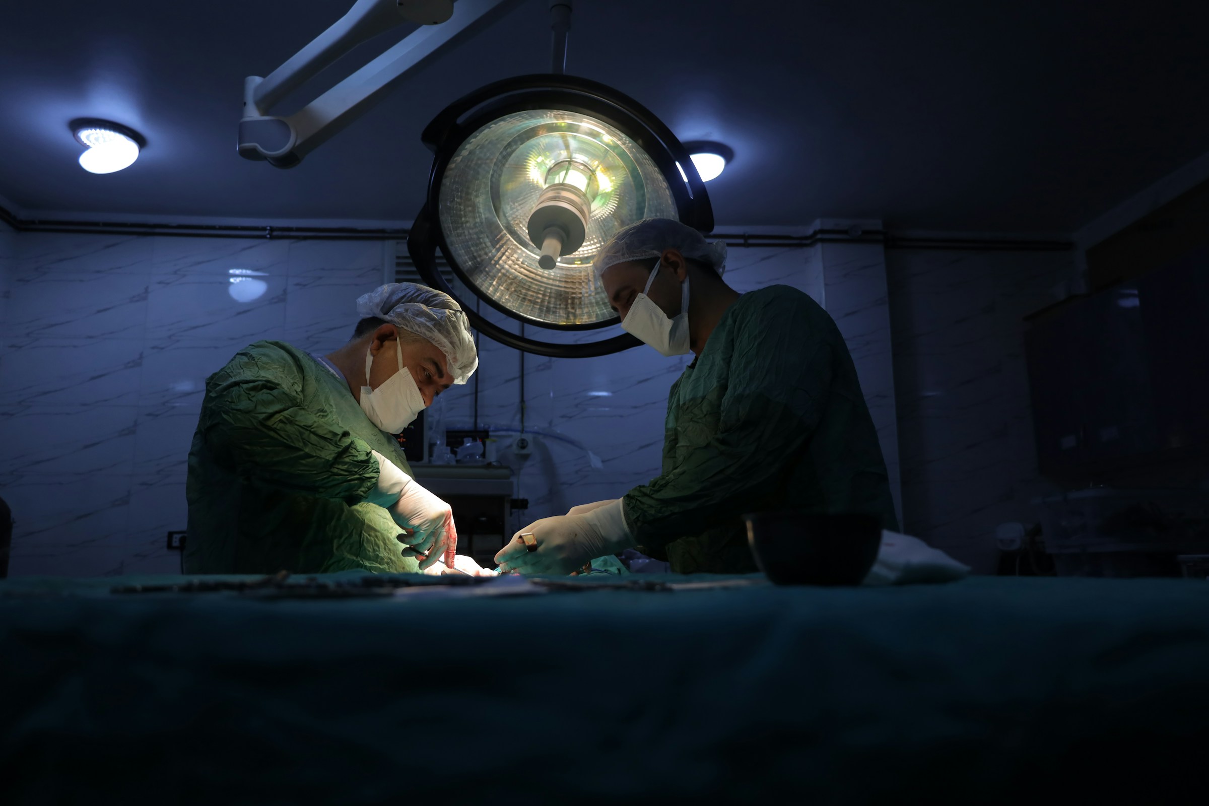 Surgeons working under theatre light