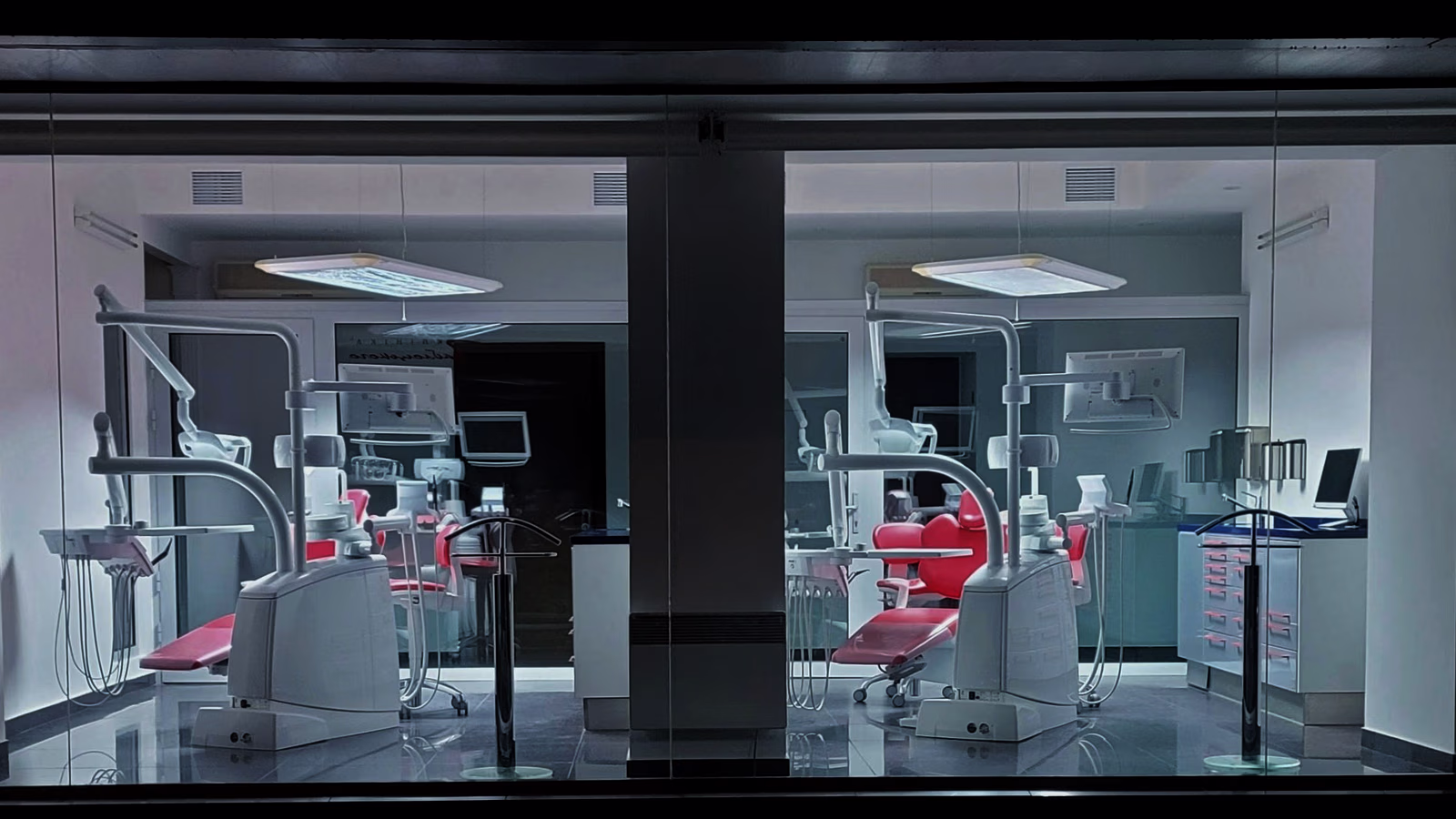 A two-chair clinic at night, seen from the street